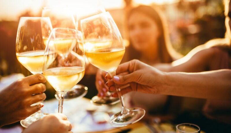People,Clinking,Glasses,With,Wine,On,The,Summer,Terrace,Of