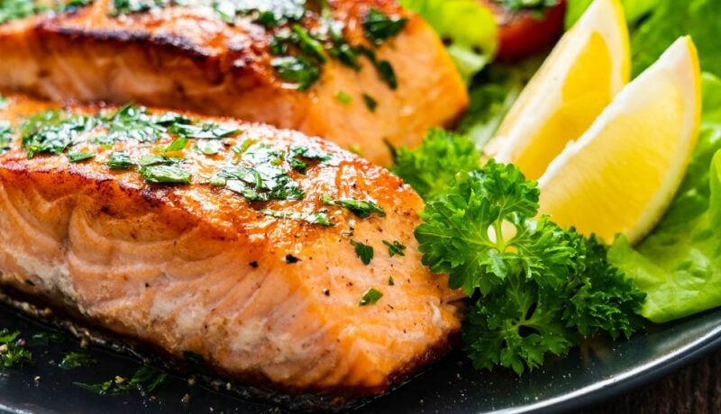 Fried,Salmon,Steaks,With,Vegetables,On,Wooden,Table