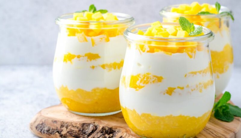 Three,Glass,Jars,With,Greek,Yogurt,And,Mango,On,A
