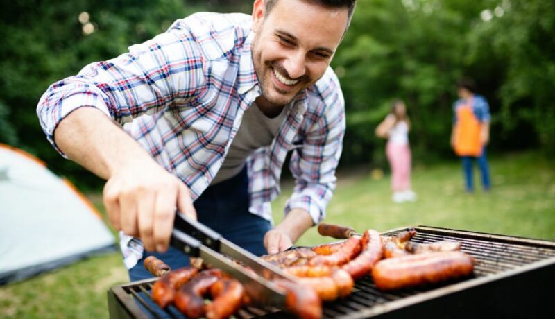 Man,Cooking,Meat,On,Barbecue,Grill,At,Outdoor,Summer,Party