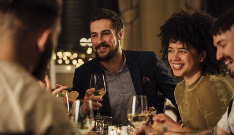 Group,Of,Friends,Are,Enjoying,A,Meal,In,A,Restaurant.